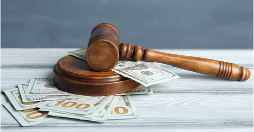 Image of a gavel and money representing economic and law concept. 